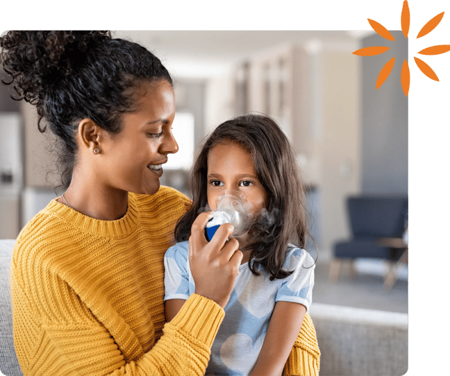 Caregiver helping a child use a nebulizer mask.